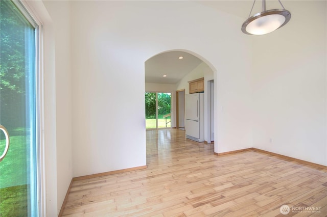 8391 Richmond Park Rd, Birch Bay, WA 98230 - unfurnished room featuring light wood-type flooring, arched walkways, vaulted ceiling, and recessed lighting