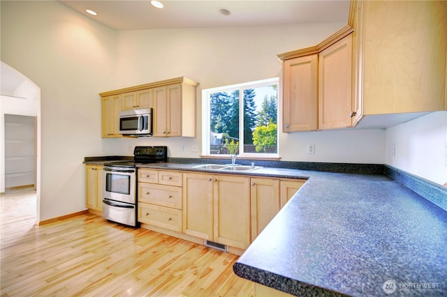 8391 Richmond Park Rd, Birch Bay, WA 98230 - kitchen with stainless steel appliances, light brown cabinets, dark countertops, recessed lighting, and high vaulted ceiling
