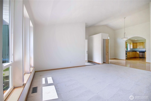 8391 Richmond Park Rd, Birch Bay, WA 98230 - unfurnished living room featuring arched walkways, lofted ceiling, and light carpet