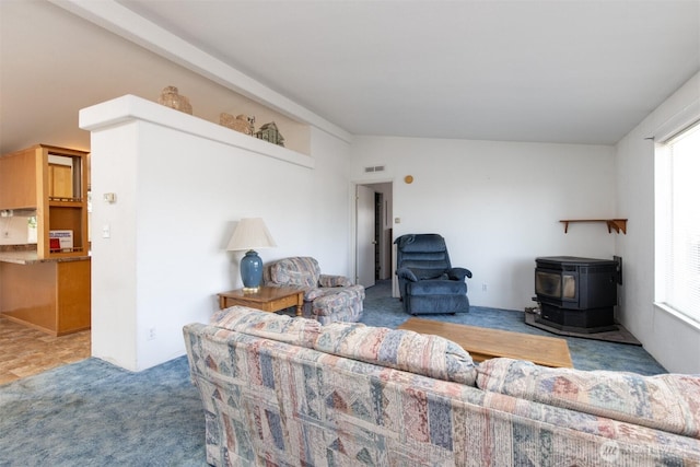 212S 3rd St, Almira, WA 99103 - living room with a wood stove, healthy amount of natural light, carpet flooring, and lofted ceiling