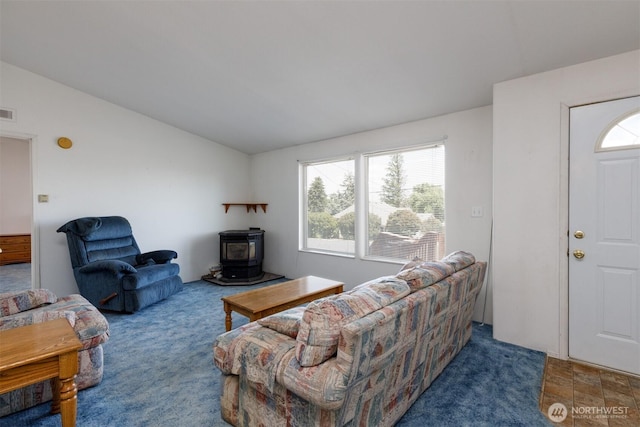 212S 3rd St, Almira, WA 99103 - living room featuring a wood stove, lofted ceiling, and carpet