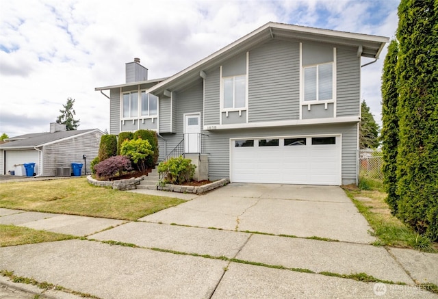 1938 66th Ave NE, Tacoma, WA 98422 - split foyer home featuring a garage, a chimney, and driveway