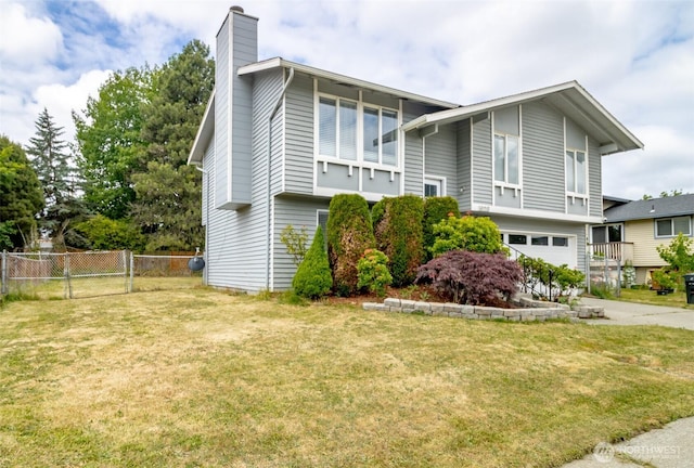 1938 66th Ave NE, Tacoma, WA 98422 - view of side of home featuring a chimney, an attached garage, and concrete driveway