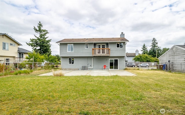 1938 66th Ave NE, Tacoma, WA 98422 - rear view of house featuring a balcony, a patio area, a chimney, and a fenced backyard