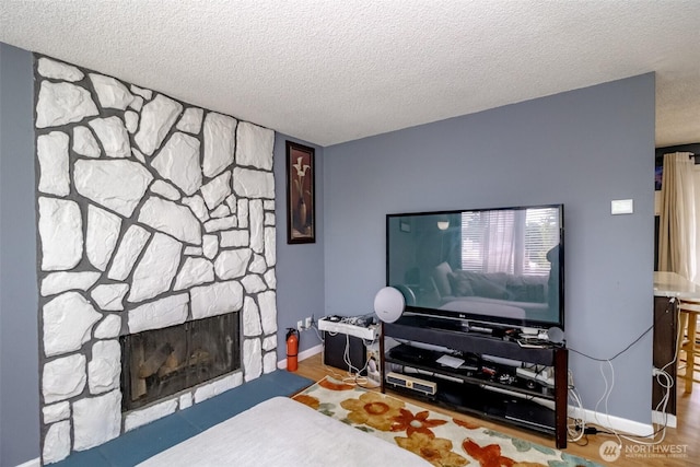 1938 66th Ave NE, Tacoma, WA 98422 - living room featuring a textured ceiling, a fireplace, and wood finished floors