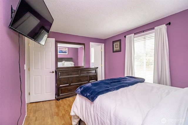 1938 66th Ave NE, Tacoma, WA 98422 - bedroom with light wood-type flooring and a textured ceiling