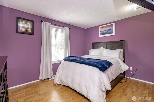 1938 66th Ave NE, Tacoma, WA 98422 - bedroom with light wood-style flooring and a textured ceiling