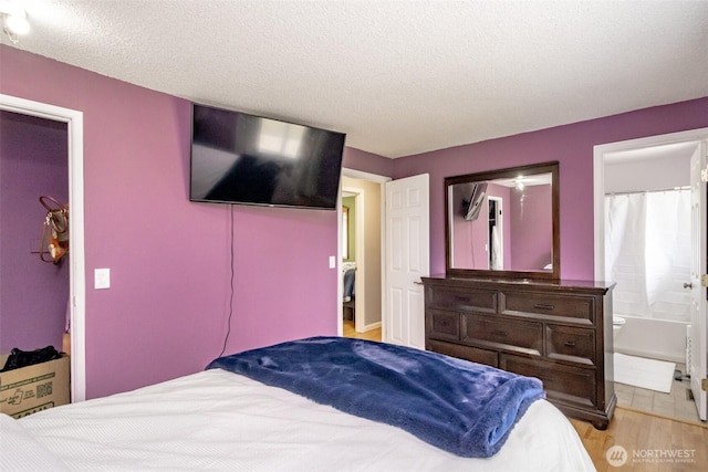 1938 66th Ave NE, Tacoma, WA 98422 - bedroom with light wood-type flooring, a textured ceiling, and ensuite bath