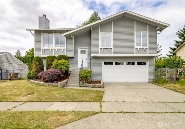 1938 66th Ave NE, Tacoma, WA 98422 - bi-level home with an attached garage, a chimney, and driveway