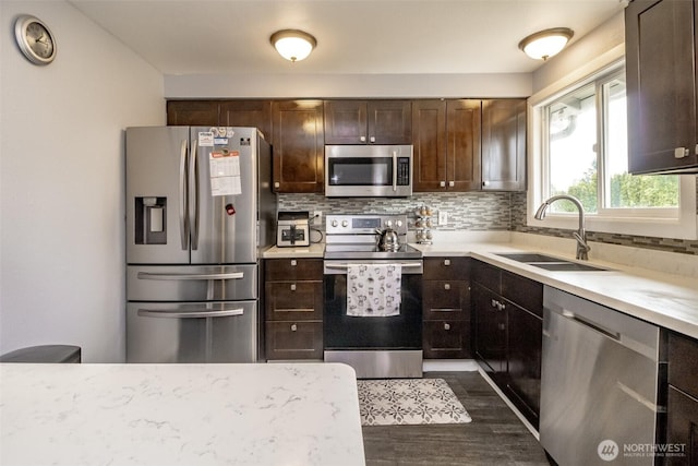 1938 66th Ave NE, Tacoma, WA 98422 - kitchen with stainless steel appliances, dark wood-style flooring, decorative backsplash, dark brown cabinetry, and light countertops