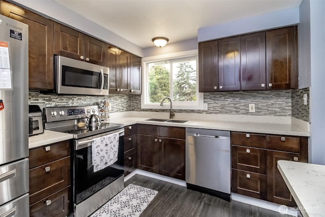 1938 66th Ave NE, Tacoma, WA 98422 - kitchen with stainless steel appliances, light countertops, dark brown cabinets, and tasteful backsplash