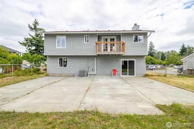 1938 66th Ave NE, Tacoma, WA 98422 - back of house featuring a balcony, a patio, a chimney, and french doors