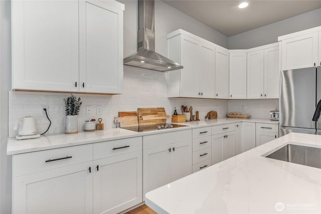4561 Albatross St, Port Townsend, WA 98368 - kitchen with wall chimney exhaust hood, freestanding refrigerator, light stone counters, black electric cooktop, and tasteful backsplash