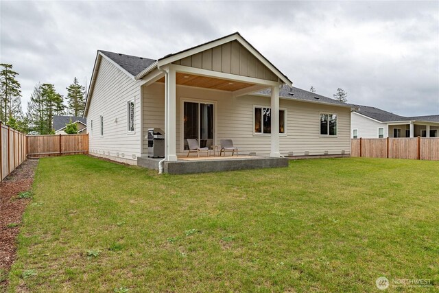 4561 Albatross St, Port Townsend, WA 98368 - back of property featuring board and batten siding, a patio area, and a fenced backyard