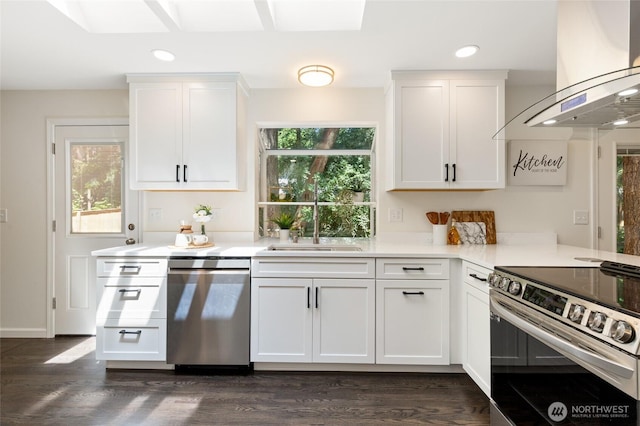 604 N 178th St, Shoreline, WA 98133 - kitchen featuring appliances with stainless steel finishes, island range hood, white cabinets, recessed lighting, and dark wood-type flooring