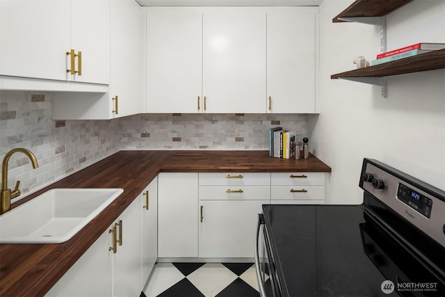 408 Bellevue Ave E Unit 306, Seattle, WA 98102 - kitchen with range with electric cooktop, butcher block countertops, backsplash, and white cabinets