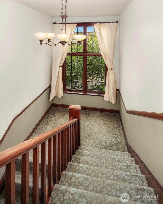 408 Bellevue Ave E Unit 306, Seattle, WA 98102 - stairway featuring a chandelier and baseboards