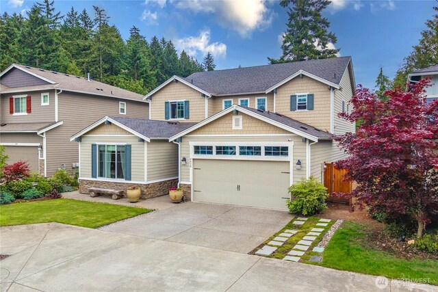 4410 Sentinel Ct, Gig Harbor, WA 98332 - craftsman-style house featuring stone siding, concrete driveway, roof with shingles, and an attached garage