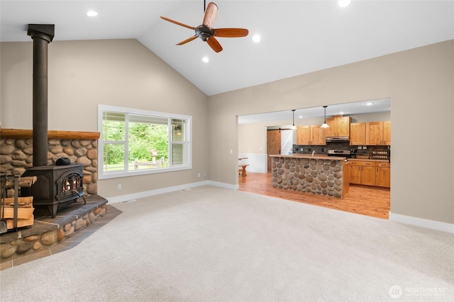 8012 105th Ave SW, Olympia, WA 98512 - living room with a wood stove, high vaulted ceiling, light carpet, recessed lighting, and ceiling fan