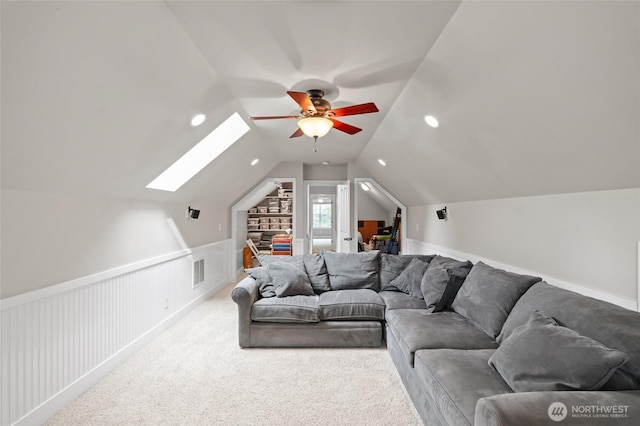 8012 105th Ave SW, Olympia, WA 98512 - living room with ceiling fan, a skylight, a wainscoted wall, lofted ceiling, and carpet flooring