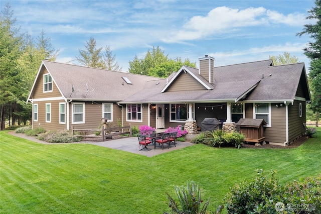 8012 105th Ave SW, Olympia, WA 98512 - back of property featuring a chimney, a patio, a lawn, and a shingled roof