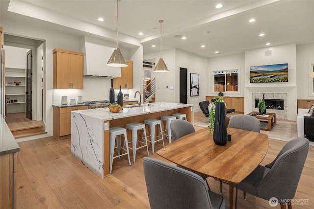 9008 NE 143rd St, Kirkland, WA 98034 - dining space with light wood finished floors, recessed lighting, and a fireplace