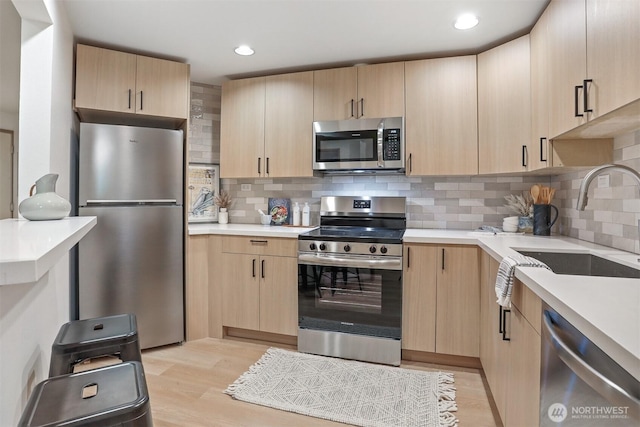 1100 E Harrison St Unit 103, Seattle, WA 98102 - kitchen featuring appliances with stainless steel finishes, light brown cabinets, light countertops, and recessed lighting