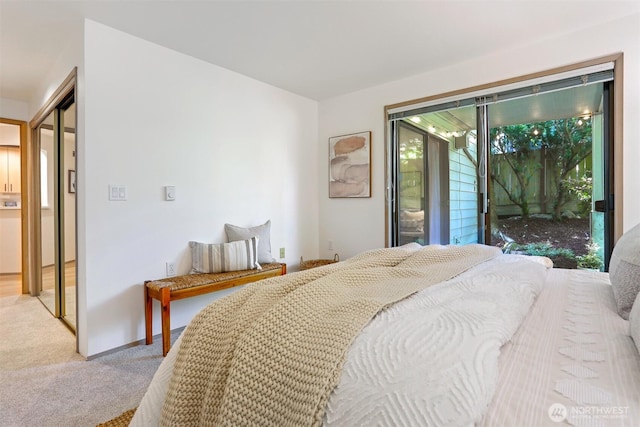 1100 E Harrison St Unit 103, Seattle, WA 98102 - carpeted bedroom featuring access to exterior and baseboards