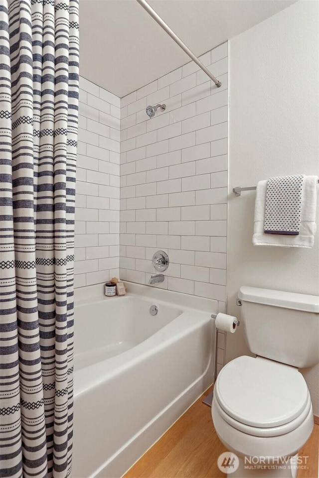 1100 E Harrison St Unit 103, Seattle, WA 98102 - bathroom with shower / bath combination with curtain and wood finished floors