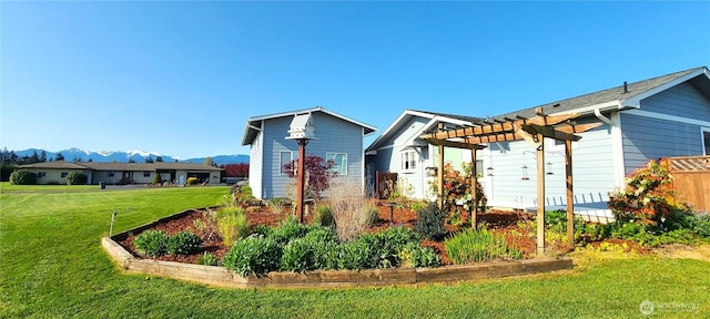 51 Sheree Ln, Sequim, WA 98382 - back of house with a pergola, a mountain view, and a lawn