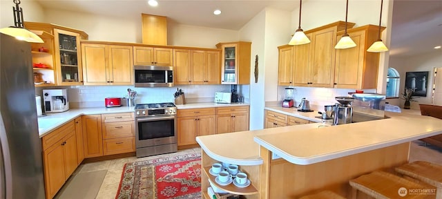 51 Sheree Ln, Sequim, WA 98382 - kitchen featuring appliances with stainless steel finishes, backsplash, a breakfast bar, light countertops, and recessed lighting