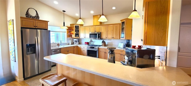 51 Sheree Ln, Sequim, WA 98382 - kitchen with stainless steel appliances, a peninsula, decorative backsplash, light countertops, and glass insert cabinets