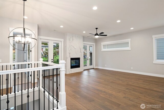 7559 S 130th Pl, Seattle, WA 98178 - unfurnished living room featuring french doors, recessed lighting, wood finished floors, ceiling fan, and a chandelier