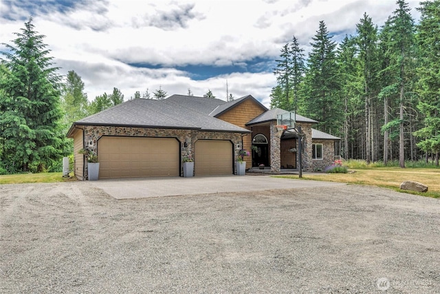 15949 159th Ln SE, Yelm, WA 98597 - view of front of property with driveway, an attached garage, stone siding, a front lawn, and roof with shingles