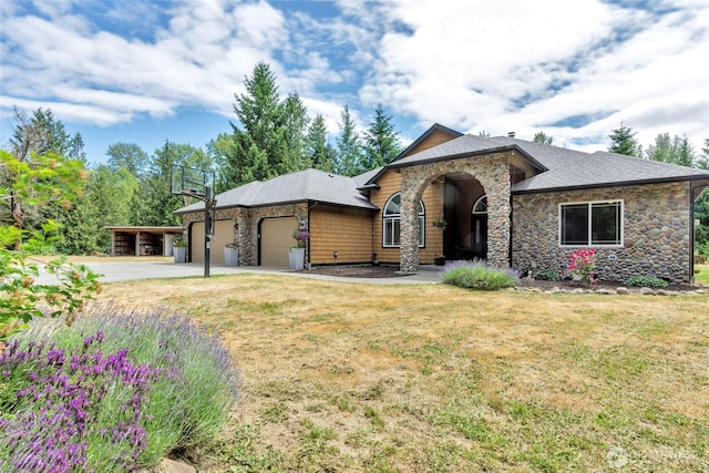 15949 159th Ln SE, Yelm, WA 98597 - view of front facade with stone siding, an attached garage, a front yard, and driveway