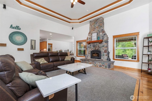 15949 159th Ln SE, Yelm, WA 98597 - living room with wood finished floors, crown molding, a ceiling fan, a high ceiling, and a raised ceiling