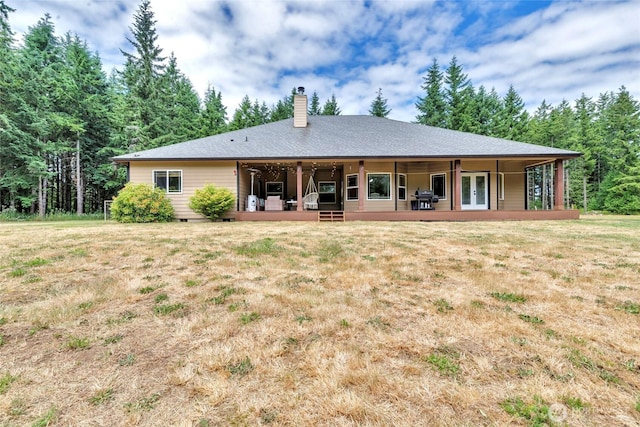 15949 159th Ln SE, Yelm, WA 98597 - back of property featuring french doors, a chimney, and a yard