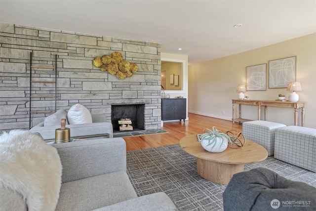 10718 12th Ave NW, Seattle, WA 98177 - living room featuring wood finished floors and a stone fireplace