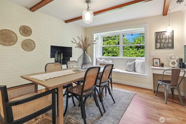 10718 12th Ave NW, Seattle, WA 98177 - dining room with beam ceiling, light wood-style floors, and a fireplace