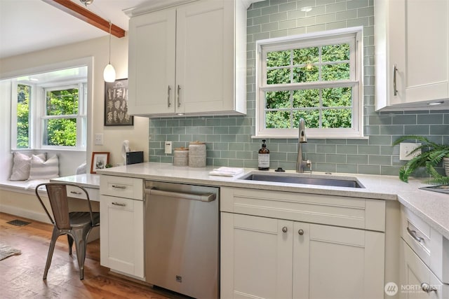 10718 12th Ave NW, Seattle, WA 98177 - kitchen featuring dishwasher, decorative backsplash, decorative light fixtures, wood finished floors, and white cabinetry