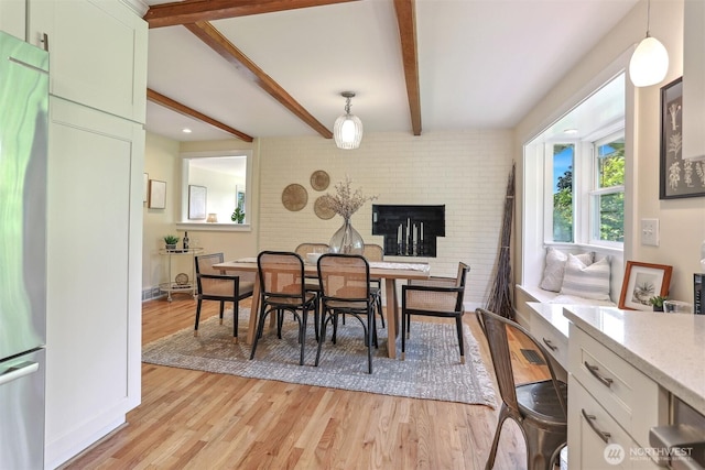 10718 12th Ave NW, Seattle, WA 98177 - dining space featuring light wood-type flooring, beam ceiling, and a fireplace