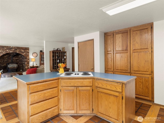 7842 Delphi Rd SW, Olympia, WA 98512 - kitchen with white electric stovetop, open floor plan, a wood stove, and light tile patterned floors