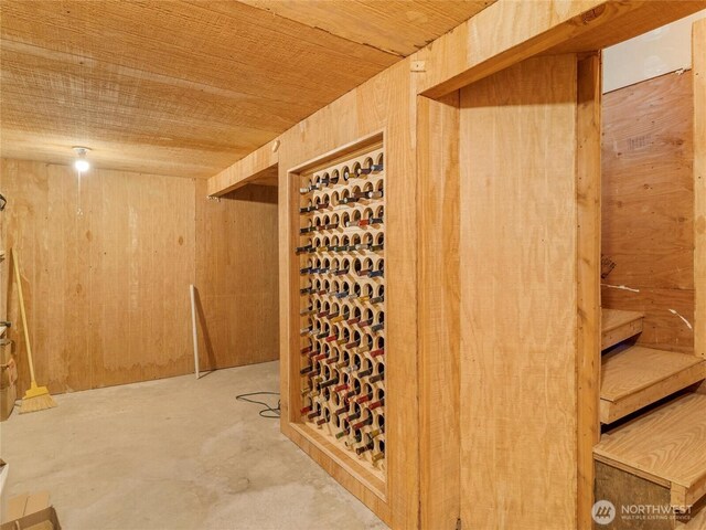 7842 Delphi Rd SW, Olympia, WA 98512 - wine area with unfinished concrete floors, wooden walls, and wood ceiling