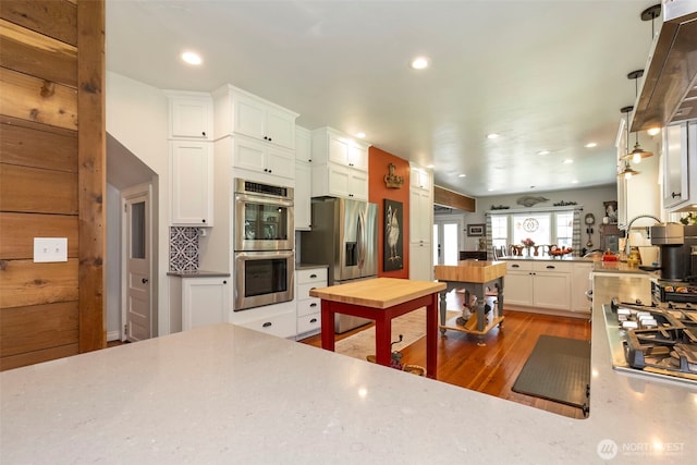 281 Jarvis Rd, Mossyrock, WA 98564 - kitchen with stainless steel appliances, wood finished floors, white cabinetry, recessed lighting, and a peninsula
