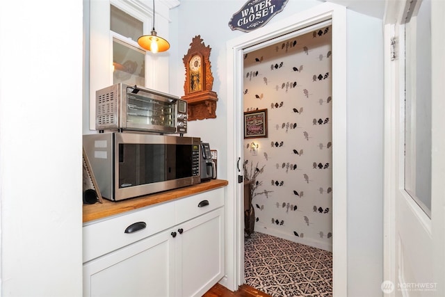 281 Jarvis Rd, Mossyrock, WA 98564 - kitchen with stainless steel microwave, butcher block counters, white cabinetry, and pendant lighting