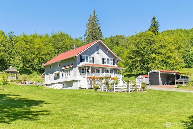 281 Jarvis Rd, Mossyrock, WA 98564 - rear view of property with a lawn, a detached carport, and a wooded view