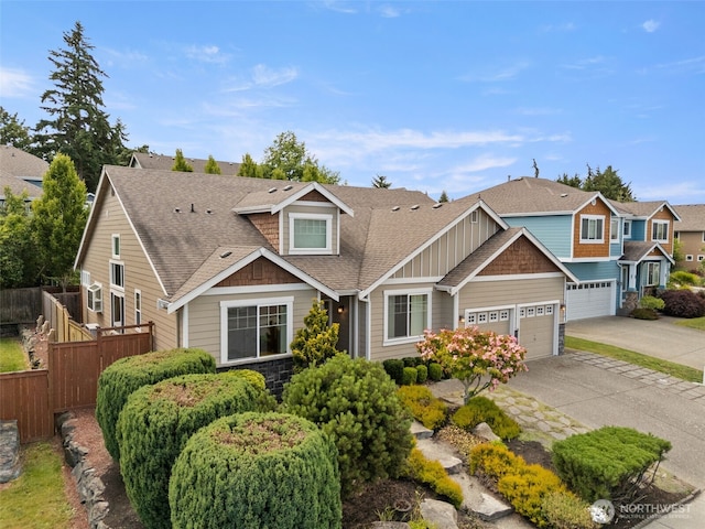18130 Sunrise Ridge Ave NE, Poulsbo, WA 98370 - view of front facade featuring driveway, board and batten siding, roof with shingles, stone siding, and a garage