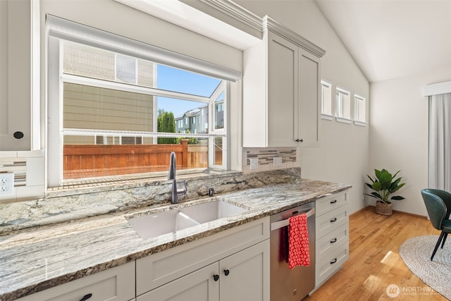 18130 Sunrise Ridge Ave NE, Poulsbo, WA 98370 - kitchen featuring dishwasher, tasteful backsplash, lofted ceiling, light wood finished floors, and light stone countertops