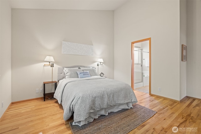 18130 Sunrise Ridge Ave NE, Poulsbo, WA 98370 - bedroom featuring light wood-style flooring, high vaulted ceiling, and connected bathroom