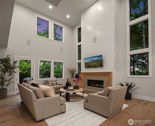 1704 172nd Ct NE, Bellevue, WA 98008 - living room with a towering ceiling, wood finished floors, a glass covered fireplace, and recessed lighting